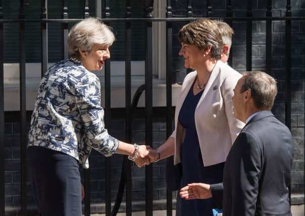 Prime Minister Theresa May greets DUP leader Arlene Foster, DUP deputy leader Nigel Dodds and DUP MP Sir Jeffrey Donaldson outside 10 Downing Street in London on Monday, June 26, 2017