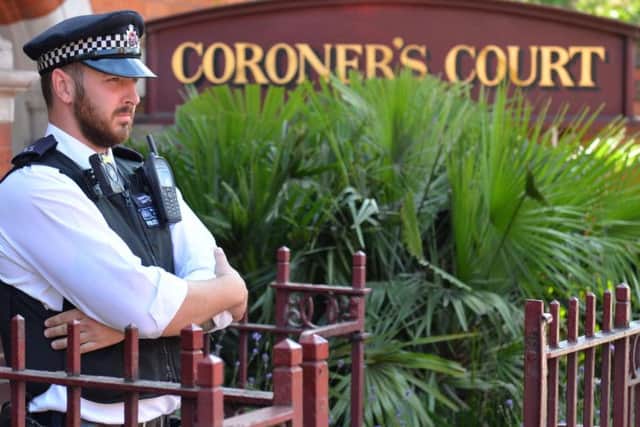 A police officer outside Westminster Coroner's Court in London where the opening of inquests into deaths of Grenfell Tower victims is due to take place