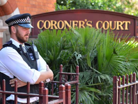A police officer outside Westminster Coroner's Court in London where the opening of inquests into deaths of Grenfell Tower victims is due to take place