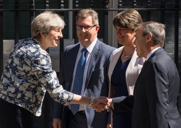 Prime Minister Theresa May greets DUP leader Arlene Foster, deputy leader Nigel Dodds and MP Sir Jeffrey Donaldson outside 10 Downing Street in London