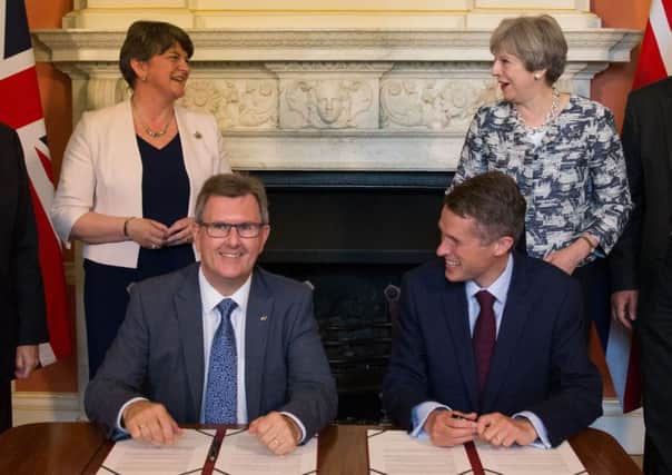 Prime Minister Theresa May stands with DUP leader Arlene Foster (left), as DUP MP Sir Jeffrey Donaldson (second right) and Parliamentary Secretary to the Treasury, and Chief Whip, Gavin Williamson, smile inside 10 Downing Street, London, after the DUP agreed a deal to support the minority Conservative government. Photo credit should read: Daniel Leal-Olivas/PA Wire