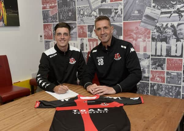 Jamie Glackin with Crusaders manager Stephen Baxter after signing a two-year deal with the Shore Road club. Pic by PressEye Ltd.