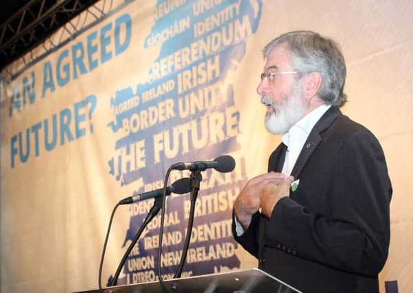 Sinn Fein of party president Gerry Adams speaking at a Sinn Fein conference on Irish unity at Belfast's Waterfront Hall last Saturday. He is pursuing a double act, says David Barbour Photo: Sinn Fein/PA Wire