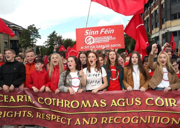 Campaigners attending a protest march in Belfast in support of an Irish language act