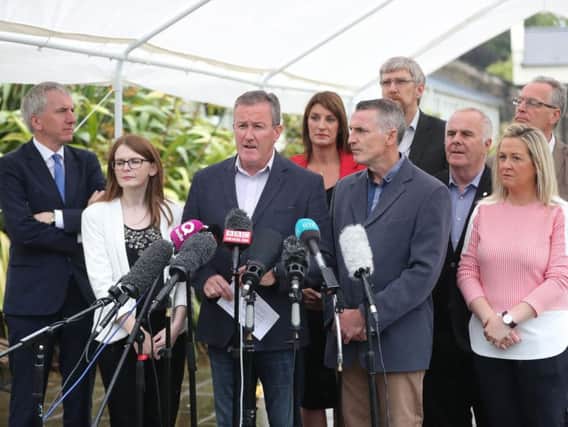Sinn Fein's Conor Murphy (centre) speaks to the media at Stormont, Belfast, as a scheduled meeting of the Stormont Assembly has been postponed amid intensive last-ditch negotiations to restore powersharing before today's 4pm deadline.