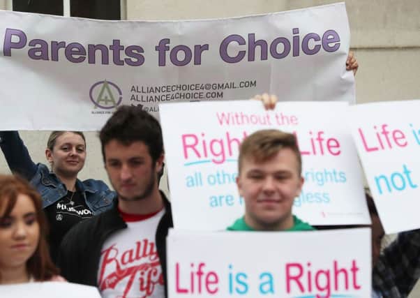 Pro-choice and anti-abortion campaigners outside the Royal Courts of Justice, Belfast, where the Court of Appeal allowed an appeal against a lower court's ruling that abortion legislation was incompatible with the UK's Human Rights Act. Later in the day, the UK government declared it would offer free abortions to Northern Irish women.