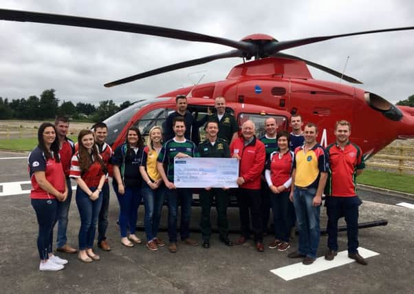 Mourne Wall walk participants from Co Down YFC presenting their cheque to Rodney Connor from Air Ambulance NI