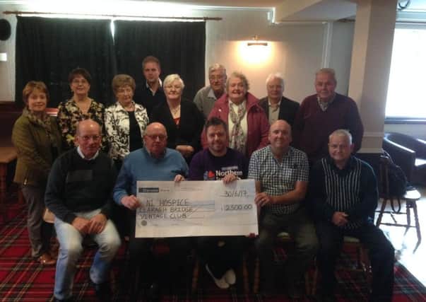 Members of Claraghbridge Vintage Club and the Cunningham family make the cheque presentation to the NI Hospice