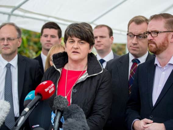 DUP leader Arlene Foster speaking to the media accompanied by party colleagues at Stormont Castle