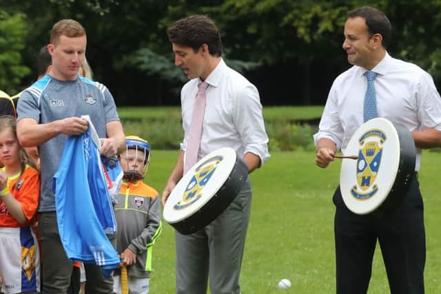 Canadian Prime Minister Justin Trudeau (centre) is presented with an Irish football shirt by Dublin GAA footballer Ciaran Kilkenny, after receiving a Bodhran (Irish drum) with Irish Taoiseach Leo Varadkar, after they held a press conference at Farmleigh House in Dublin.  Niall Carson/PA Wire