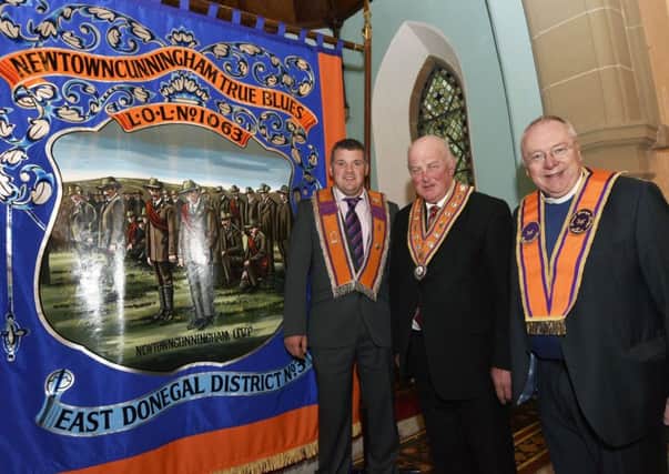 Graeme Parke, WM, Edward Stevenson, grand master of the Grand Orange Lodge of Ireland, and Rev Mervyn Gibson, grand secretary of the Grand Orange Lodge of Ireland, with the new Newtowncunningham banner