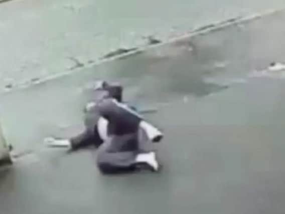 Pedestrian left lying on street after runaway car knocks him down