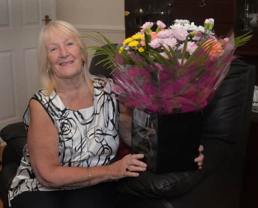Maureen Creaney with some of the many flowers she has received since the incident. INPT27-221.