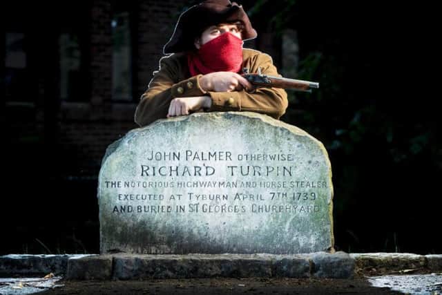 Simon Alnaimi, dressed as Dick Turpin, next to what was, until new evidence cast doubt on the claim, believed to be the grave of the infamous 18th century highwayman, in St Georges graveyard, York.
