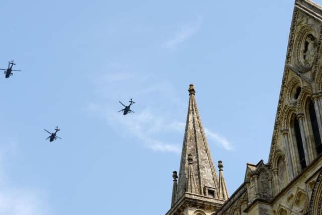 Three Apache helicopters fly past Salisbury Cathedral to celebrate the Army Air Corps 60th anniversary