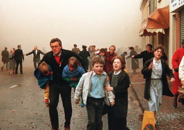 Men, women and children flee in the aftermath of the Enniskillen Poppy Day massacre in 1987. The IRA blew up the Remembrance Day service, killing 11 people and injuring over 60 who were standing in and around the area. Pic: Pacemaker.
