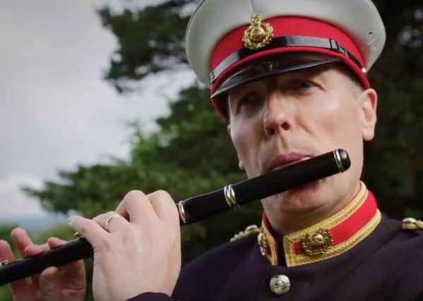 A bandsman playing music in the Belfast Orangefest promotional video