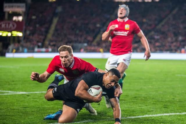 All Blacks' Ngani Laumape scores their first try despite Liam Williams of the Lions