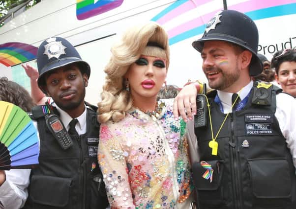 Police with cross-dresser Jodie Harsh at London gay pride on Saturday