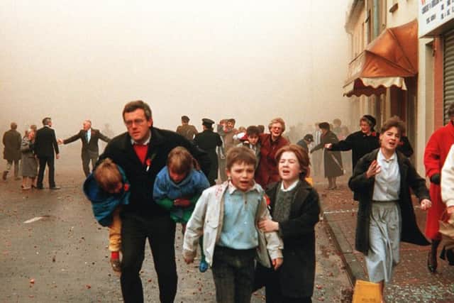 Children cry, elderly people rush away and there is general confusion after the 1987 IRA Poppy Day massacre in Enniskillen, in which 11 Protestants were murdered at a remembrance service. Picture Pacemaker Press
