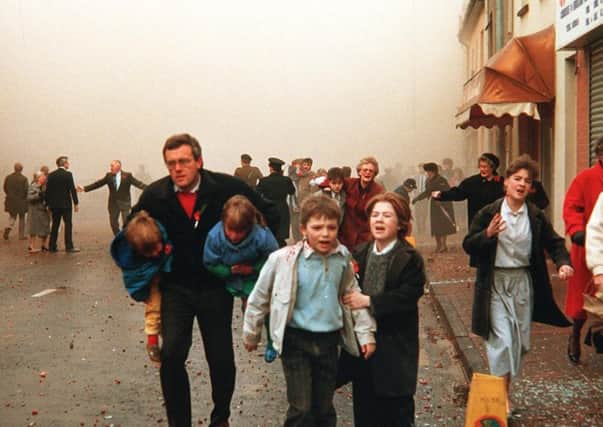 Children cry, elderly people rush away and there is general confusion after the 1987 IRA Poppy Day massacre in Enniskillen, in which 11 Protestants were murdered at a remembrance service. Picture Pacemaker Press