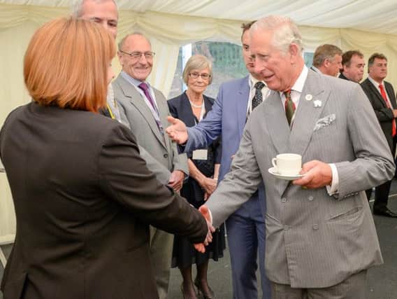 The Prince of Wales has a cup of tea as he chats with company members after officially opening Volac International's new biomass plant in Ciliau Aeron, which uses sustainable wood fuel to produce energy, before attending a reception with staff and stakeholders in Dyffryn Aeron Valley, Felinfach.