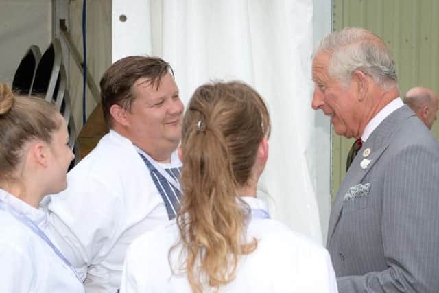 The Prince of Walesc speaks with caterers during a visit to Volac International's new biomass plant in Ciliau Aeron, which uses sustainable wood fuel to produce energy, before attending a reception with staff and stakeholders in Dyffryn Aeron Valley, Felinfach
