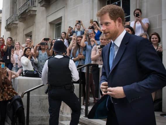 Prince Harry is photographed by members of the public as he leaves the London School of Hygiene and Tropical Medicine in Bloomsbury, London where he saw the work being undertaken to combat some of the world's most pressing health issues
