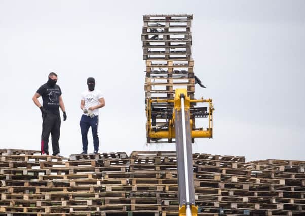 Masked men on top of the bonfire at inverary playing fields yesterday afternoon