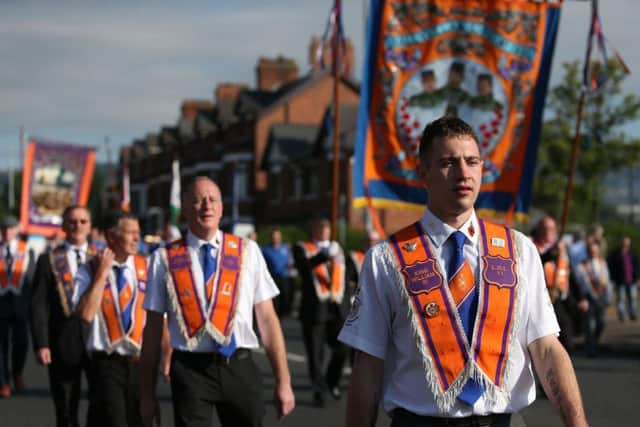 Orange Order members march past Ardoyne shops on the Crumlin Road in Belfast as part of the 'Twelfth of July' celebrations. PRESS ASSOCIATION Photo. Picture date: Wednesday July 12, 2017
