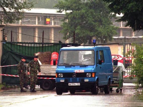 In this June 29, 1996 file photo British soldiers walk to a police van that hides partly a pickup truck in front of a side entrance to the Osnabrueck British Quebec barracks after a mortar attack