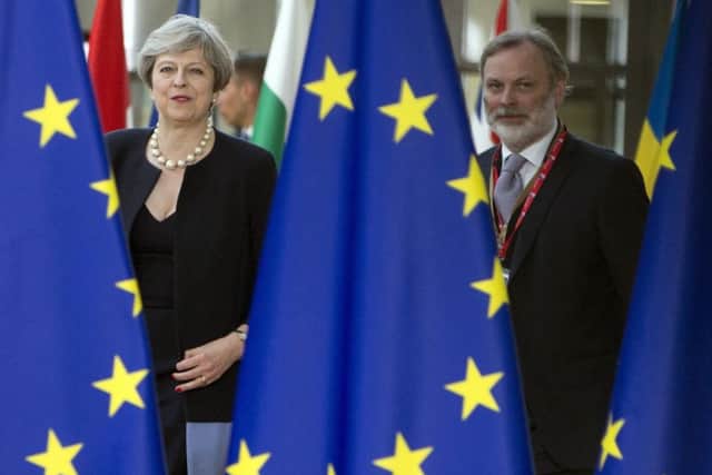 British Prime Minister Theresa May, left, and UK representative to the EU Tim Barrow arrive for an EU summit at the Europa building in Brussels on June 22, 2017. What will be the relationship between Britain and the EU, Latvians were wondering after Brexit? (AP Photo/Virginia Mayo)