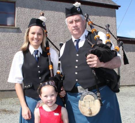 DUP Westminster candidate Diane Forsythe with daughter Brooke and father DUP Councillor Glyn Hanna, prior to parading with Ballymartin Pipe Band.