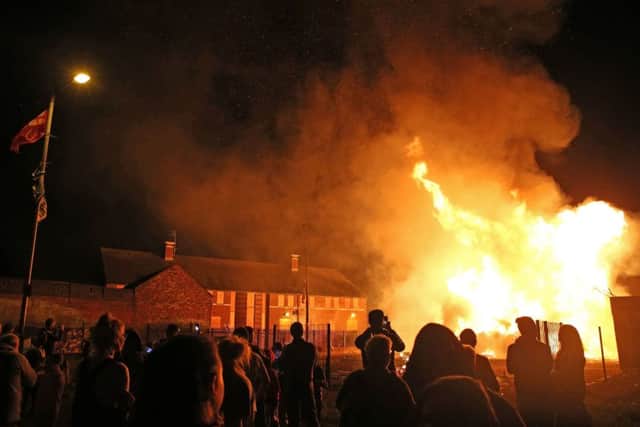 Am 11th night bonfire at Ravenscroft Avenue in Belfast is lit. Photo: PA Wire