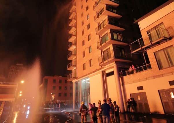 General view of fire officers at the apartment block that was damaged beside the Sandy Row bonfire in south Belfast.

Photo by Kelvin Boyes / Press Eye