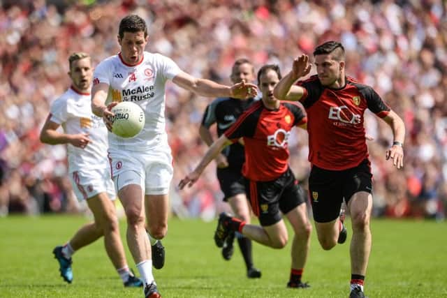 Sean Cavanagh of Tyrone  in action against Niall McParland of Down
