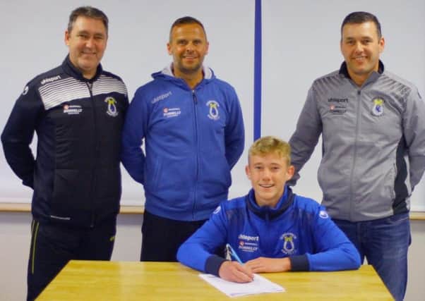 Liam Hughes signs his three-year professional deal with Dungannon Swifts. Looking on are, from left, Dixie Robinson (under 20s' manager), Rodney McAree (first-team head coach) and Keith Boyd (chairman). Pic by Simon Graham/Dungannon Swifts.