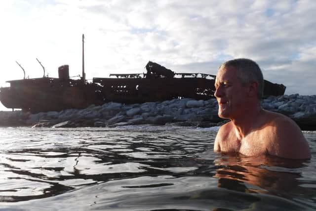 Photographer Paul McCambridge at the MV Plassey shipwreck on the Aran Islands. The Inisheer shipwreck features in the intro of the Father Ted TV series.