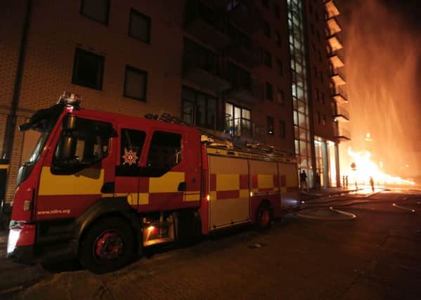 General view of fire officers at the apartment block that was damaged beside the Sandy Row bonfire in south Belfast.

Photo by Kelvin Boyes/Press Eye