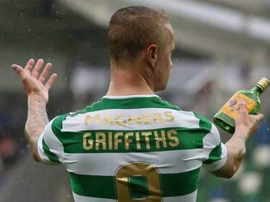 Celtic striker Leigh Griffiths picks up a glass bottle which appeared to be thrown towards him during Friday's Champions League clash at Windsor Park