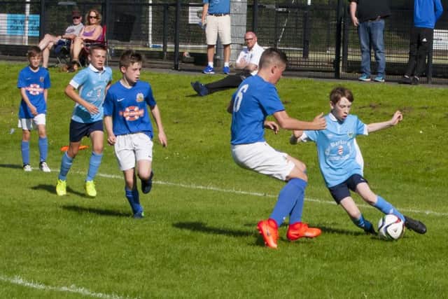Magherafelt Sky Blues diminutive winger Michael McKay attempts to get past marker, Glenavon's Matthew King during their Hughes Insurance Foyle Cup encounter at St. Columb's Park, Derry on Monday afternoon.