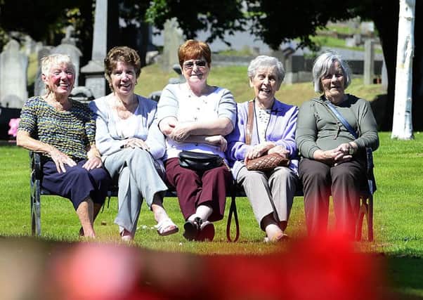 Phyllis, Stella, Anne Frances, Pasty and Clementine enjoy the summer sun on the Falls Road in Belfast on Tuesday