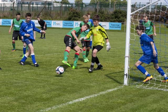 Glentoran's Joe Hopes sidefoots this close range effort just wide of the upright in the early stages of the under-13 Hughes Insurance Foyle Cup at Wilton Park
