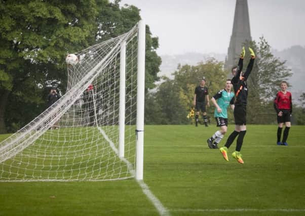 Tobermore goalkeeper Matthew Clark looks back as this 25 yard lob lands in the back of the nets in the U15 game against Derry City