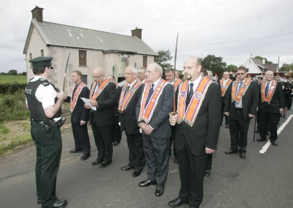 Worshipful master Bro John Finlay reads a statement to a police officer as the lodge are prevented from parading in Dunloy in 2014. Picture Steven McAuley/Kevin McAuley Photography Multimedia