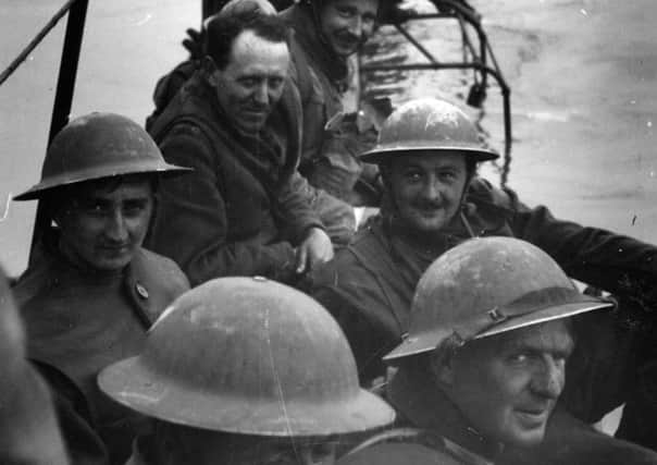 Members of Royal Ulster Rifles waiting on improvised pier of lorries to evacuate Dunkirk