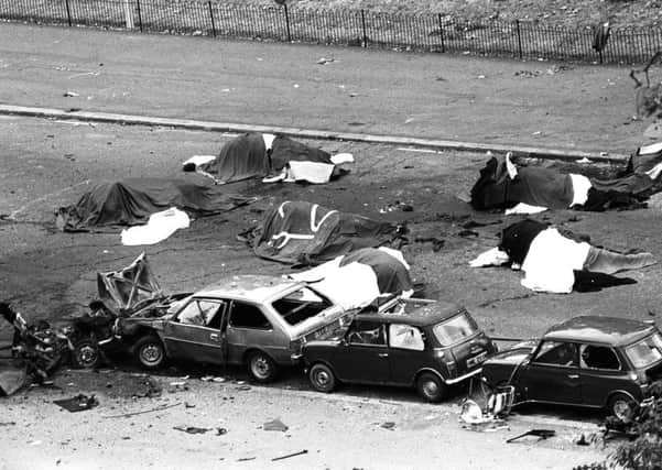 Dead horses covered up and wrecked cars at the scene of carnage in Rotten Row, Hyde Park, after an IRA bomb exploded as the Household Cavalry was passing in 1982