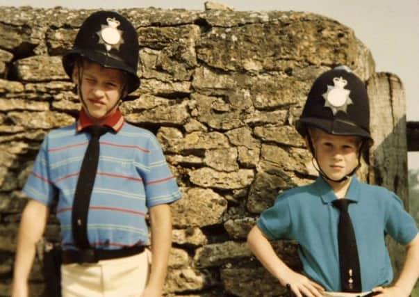 Princes William (left) and Harry dressed as policemen