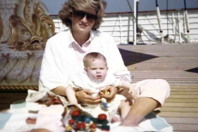 Diana, Princess of Wales, sitting and playing with Prince Harry on the Royal Yacht Britannia