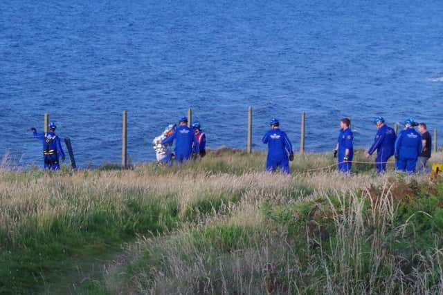 The moment the Coastguard ropes team pulled a 16-year-old girl, wrapped in a foil blanket, up a 100ft cliff at Castlerock tonight. She had been trapped by the incoming tide and her position was overwhelmed just as they lifted her to safety.